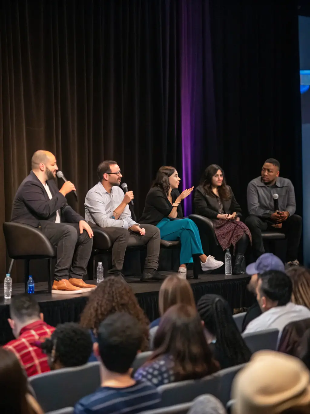 A panel discussion featuring industry experts debating the future of journalism, with a moderator guiding the conversation and audience members asking questions.